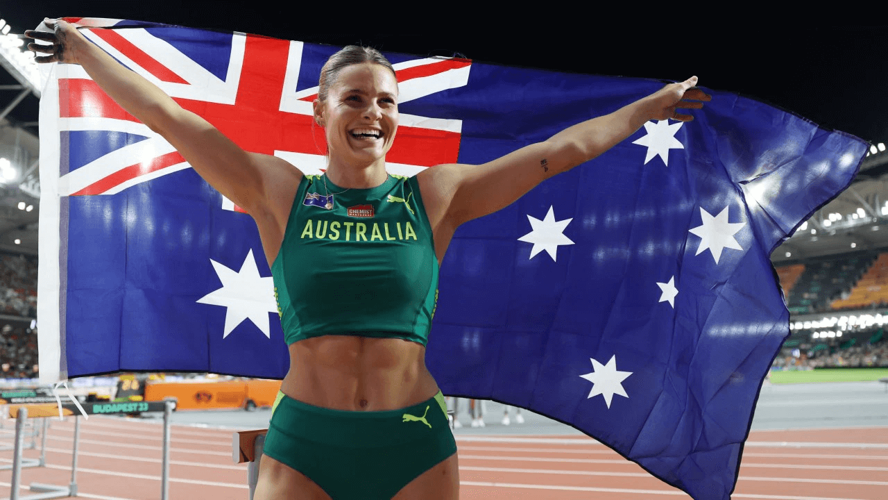 Nina Kennedy holding Australian flag as World Champion